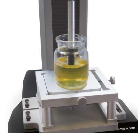 A gel sample in the test standard bottle with a cylinder probe compressing the surface to 4 mm